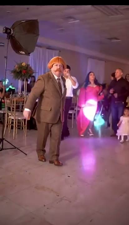 Bby Wow Dance demonstration with a brown-suited dancer and guests in a banquet hall